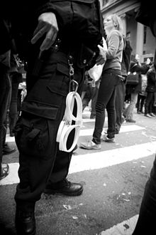 250px Policeman carrying plasticuffs